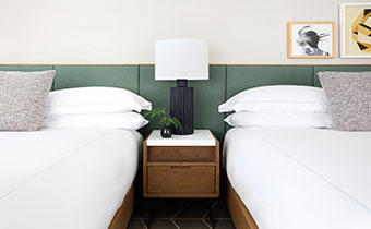 Double guest room with green headboards