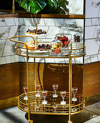 gold tray with food and beverage offerings 